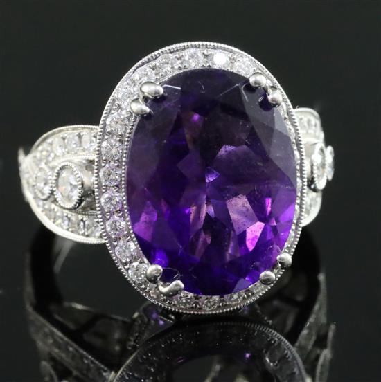 A modern 18k white gold, amethyst and diamond set dress ring, size N.